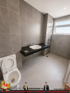 Modern gray-tiled bathroom with a white sink on a black floating countertop, a toilet to the left, and a rainfall shower by a large window.