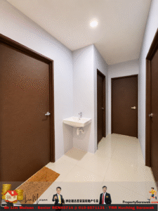 Narrow hallway with four closed wooden doors, a small wall-mounted sink on the left, beige floor tiles, and a brown rug near the foreground under a ceiling light.
