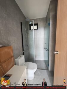 Modern gray-tiled bathroom with a glass shower enclosure, a white toilet, and a white vanity; cardboard boxes are stacked in the corner on the left.