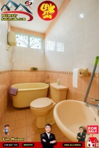 Beige bathroom with peach tile walls, a freestanding tub, toilet, and sink; window with decorative grille; cleaning tools and a 'FOR SALE' banner overlay.