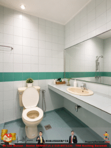 Light-blue tiled bathroom with a long vanity, beige sink, large mirror, teal wall stripe, and toilet with a small plant on the tank. (informative)