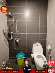 Bathroom in a property listing: modern tiled shower area with rain shower, shelf of toiletries, and a white toilet; sale branding overlays in corners.