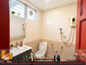 Small beige-tiled bathroom with toilet, sink, mirror, and wall-mounted shower heater; red door partially open.