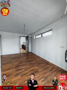 Unfurnished interior room with wooden floor, white walls, hanging ceiling wires, and an open doorway leading to another area; horizontal window on the right side.