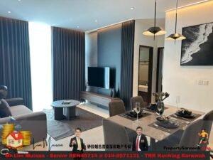 Modern open-plan living and dining area with gray sofa, round coffee table, TV on a wood console, and dark curtains in the background.