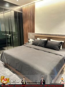 Modern hotel bedroom with gray bedding, brown upholstered headboard, wooden slat wall, and glass sliding closet on the left.