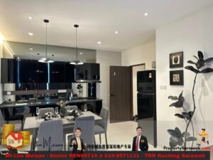 Open-plan kitchen and dining area with black glossy cabinets, a white dining table set with glassware, and a tall fridge.